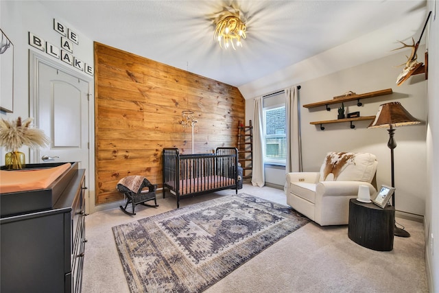 28111 Middlewater View Ln, Katy, TX 77494 - carpeted bedroom with wooden walls, a crib, and vaulted ceiling