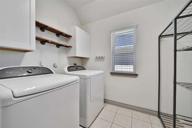 28111 Middlewater View Ln, Katy, TX 77494 - washroom featuring cabinet space, separate washer and dryer, light tile patterned flooring, and baseboards