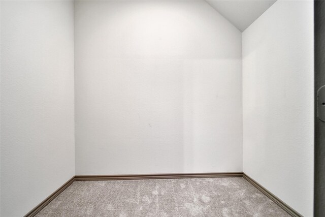 28111 Middlewater View Ln, Katy, TX 77494 - spare room featuring carpet, lofted ceiling, and baseboards