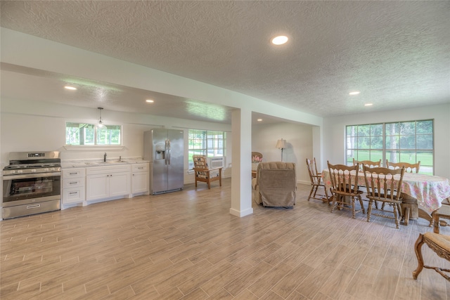 517 Lakeview Hbr, Onalaska, TX 77360 - living area with a textured ceiling, light wood-style floors, recessed lighting, baseboards, and cooling unit