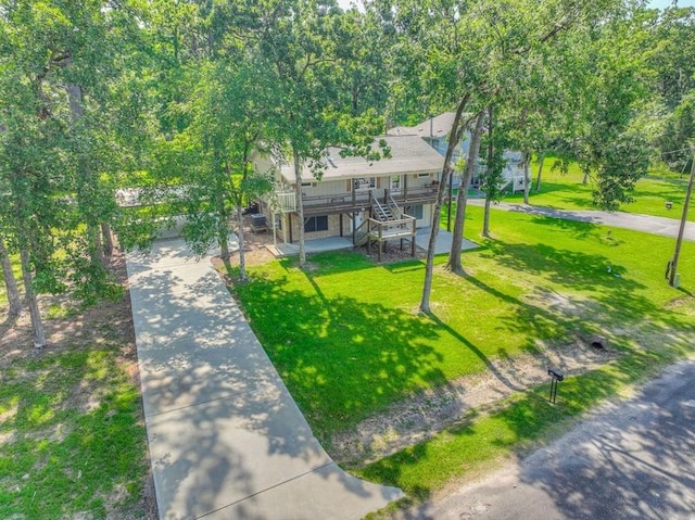 517 Lakeview Hbr, Onalaska, TX 77360 - view of front of home with a front lawn, concrete driveway, a garage, and stairway