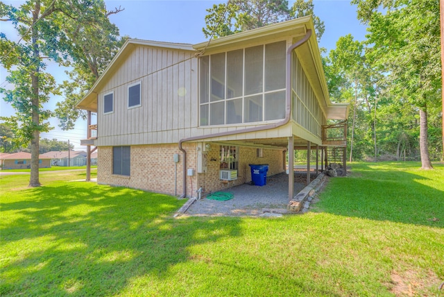 517 Lakeview Hbr, Onalaska, TX 77360 - rear view of house featuring a patio, brick siding, a yard, a sunroom, and board and batten siding