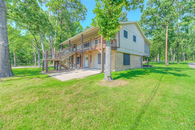 517 Lakeview Hbr, Onalaska, TX 77360 - back of house with brick siding, a yard, a deck, and stairs