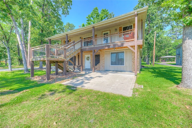 517 Lakeview Hbr, Onalaska, TX 77360 - back of house with board and batten siding, a patio, a lawn, stairs, and a deck