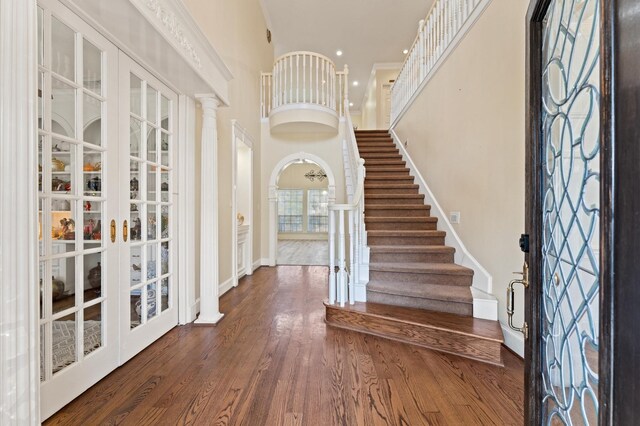 18226 Ennsbury Dr, Houston, TX 77084 - foyer featuring wood finished floors, stairs, baseboards, and a towering ceiling