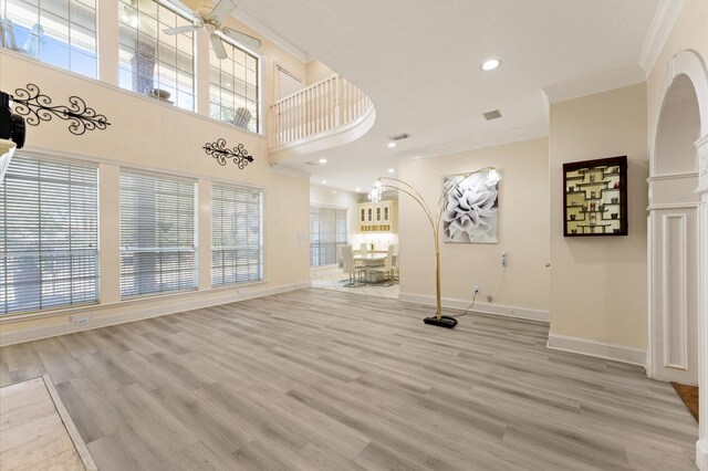 18226 Ennsbury Dr, Houston, TX 77084 - unfurnished living room with crown molding, baseboards, ceiling fan, light wood-style floors, and recessed lighting