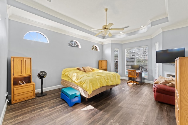 18226 Ennsbury Dr, Houston, TX 77084 - bedroom featuring ornamental molding, dark wood finished floors, multiple windows, a tray ceiling, and baseboards