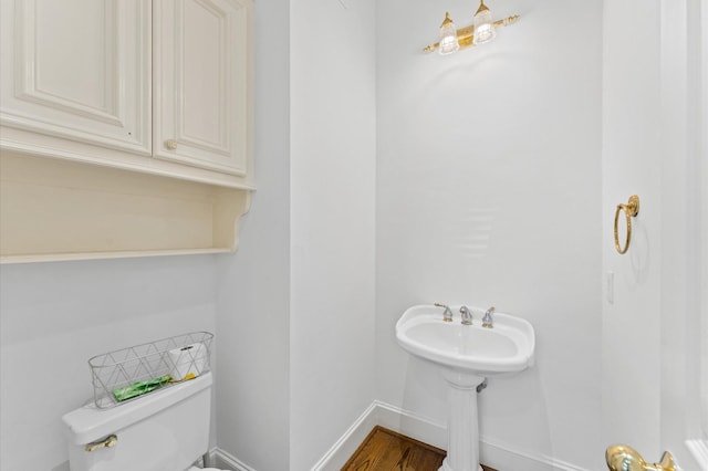18226 Ennsbury Dr, Houston, TX 77084 - half bathroom featuring toilet, baseboards, and wood finished floors