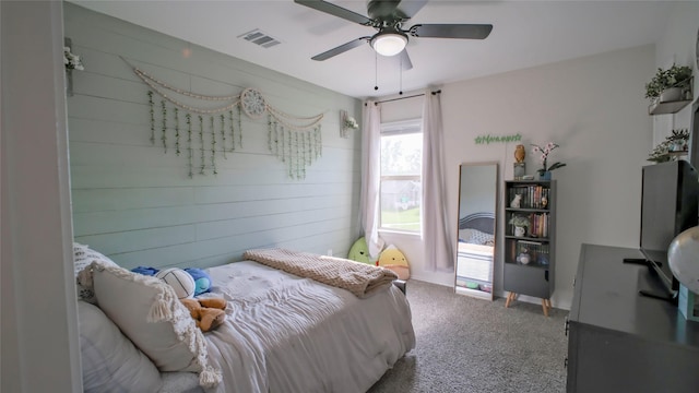 21386 Owl Rd, New Caney, TX 77357 - bedroom featuring carpet flooring, wooden walls, and a ceiling fan