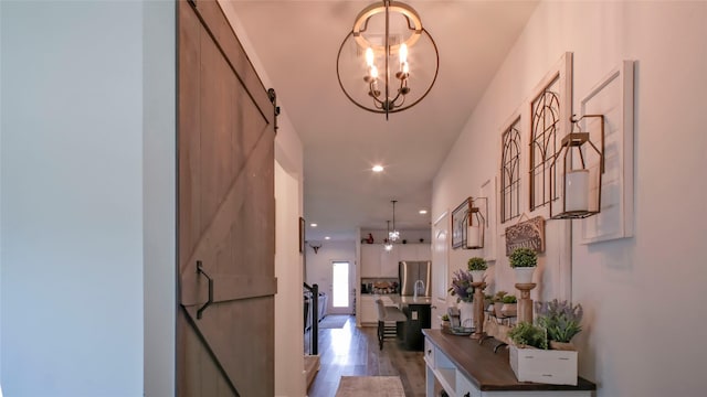 21386 Owl Rd, New Caney, TX 77357 - hallway with a barn door, a chandelier, wood finished floors, and recessed lighting