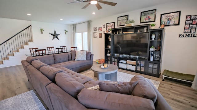 21386 Owl Rd, New Caney, TX 77357 - living area featuring ceiling fan, wood finished floors, stairway, and recessed lighting