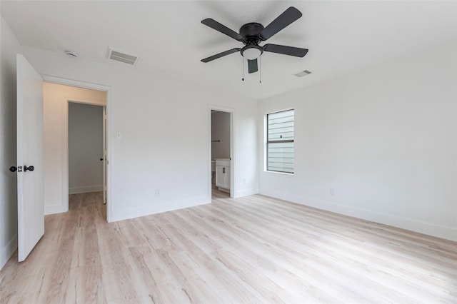 12034 Audubon Hill Ct, Houston, TX 77038 - unfurnished bedroom with light wood-type flooring, baseboards, a ceiling fan, and ensuite bath