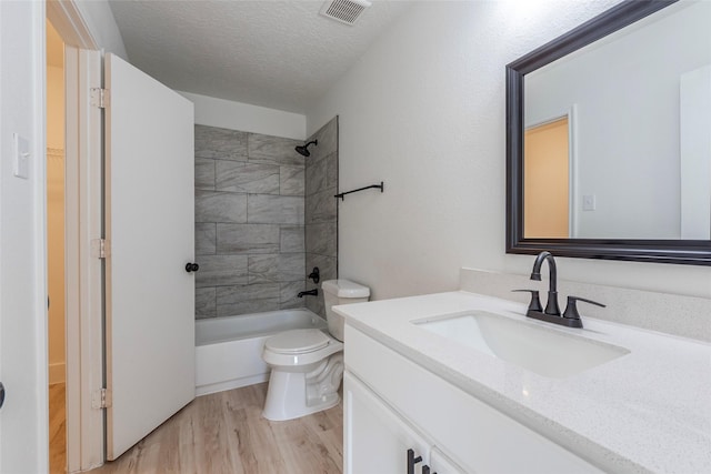 12034 Audubon Hill Ct, Houston, TX 77038 - full bathroom featuring vanity, wood finished floors, toilet,  shower combination, and a textured ceiling