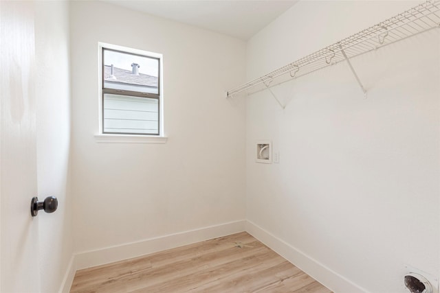 12034 Audubon Hill Ct, Houston, TX 77038 - laundry area with hookup for a washing machine, baseboards, and light wood-type flooring