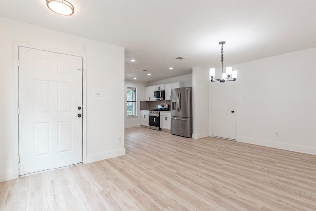 12034 Audubon Hill Ct, Houston, TX 77038 - unfurnished living room featuring a chandelier, light wood-style flooring, baseboards, and recessed lighting