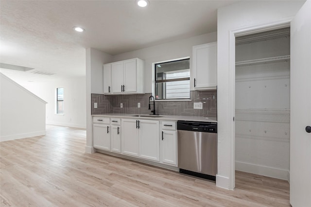 12034 Audubon Hill Ct, Houston, TX 77038 - kitchen featuring dishwasher, a sink, baseboards, tasteful backsplash, and light countertops