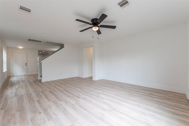 12034 Audubon Hill Ct, Houston, TX 77038 - unfurnished living room with stairs, light wood-type flooring, ceiling fan, and baseboards