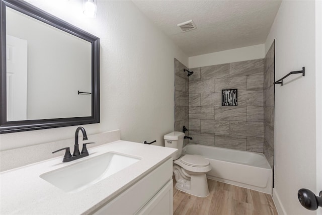 12034 Audubon Hill Ct, Houston, TX 77038 - bathroom featuring toilet, vanity, wood finished floors, shower / tub combination, and a textured ceiling
