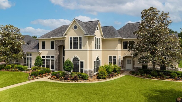 5811 Cimmaron Creek Ct, Spring, TX 77379 - view of front facade featuring stucco siding, a front yard, stone siding, and a shingled roof