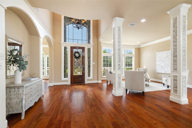 5811 Cimmaron Creek Ct, Spring, TX 77379 - foyer with baseboards, wood finished floors, a chandelier, arched walkways, and ornamental molding