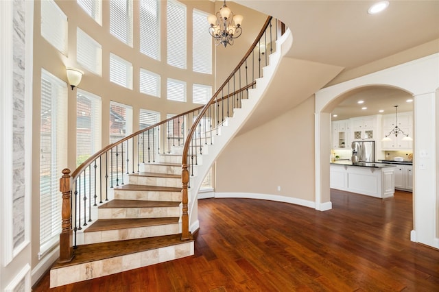 5811 Cimmaron Creek Ct, Spring, TX 77379 - stairs with hardwood / wood-style floors, a chandelier, baseboards, a towering ceiling, and recessed lighting
