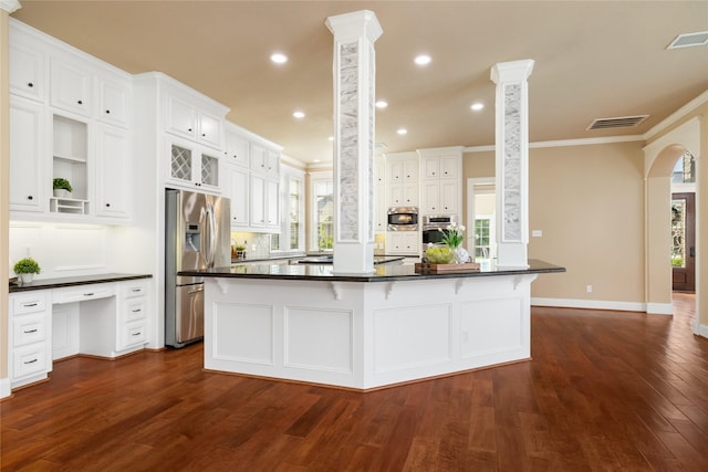 5811 Cimmaron Creek Ct, Spring, TX 77379 - kitchen featuring stainless steel appliances, dark countertops, white cabinets, ornate columns, and crown molding