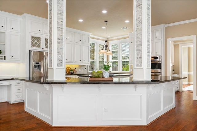 5811 Cimmaron Creek Ct, Spring, TX 77379 - kitchen featuring appliances with stainless steel finishes, white cabinets, dark wood finished floors, recessed lighting, and crown molding