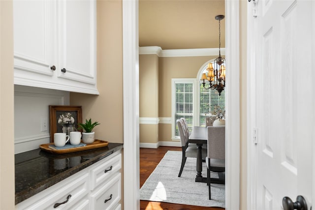 5811 Cimmaron Creek Ct, Spring, TX 77379 - dining space featuring a chandelier, dark wood-type flooring, crown molding, and baseboards