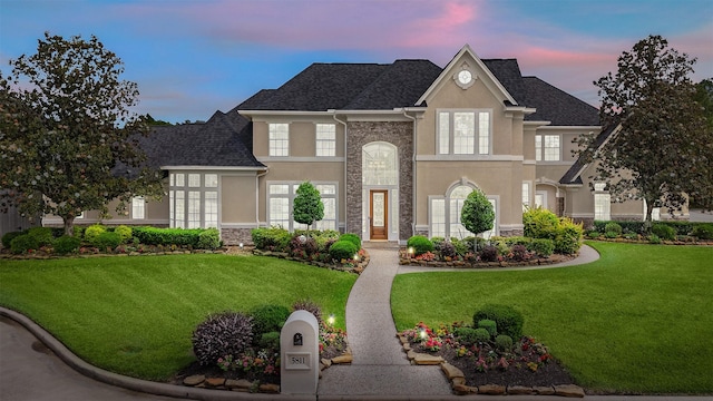 5811 Cimmaron Creek Ct, Spring, TX 77379 - view of front of house with stone siding, stucco siding, a front lawn, and a shingled roof