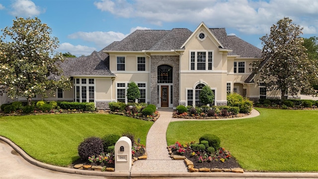 5811 Cimmaron Creek Ct, Spring, TX 77379 - view of front facade featuring stucco siding, stone siding, and a front yard