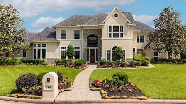 5811 Cimmaron Creek Ct, Spring, TX 77379 - view of front of home featuring stucco siding, stone siding, a front yard, and a shingled roof
