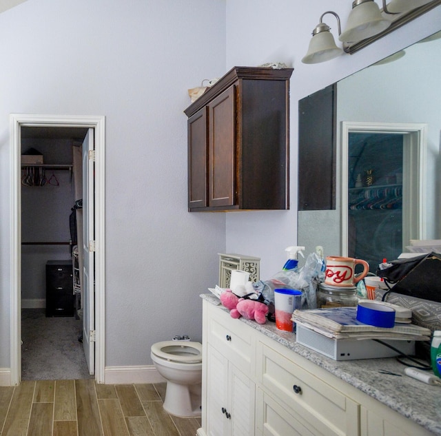 8000 Tee Dr, Austin, TX 78747 - bathroom featuring wood finished floors, baseboards, a spacious closet, and toilet
