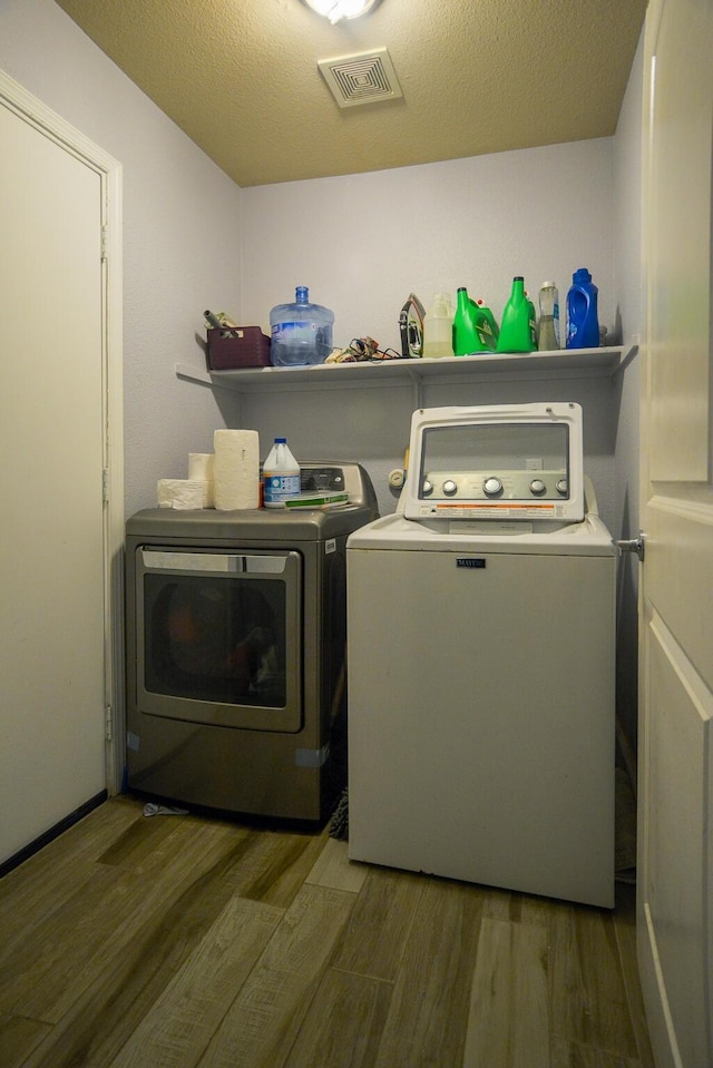 8000 Tee Dr, Austin, TX 78747 - washroom featuring washing machine and clothes dryer and wood finished floors