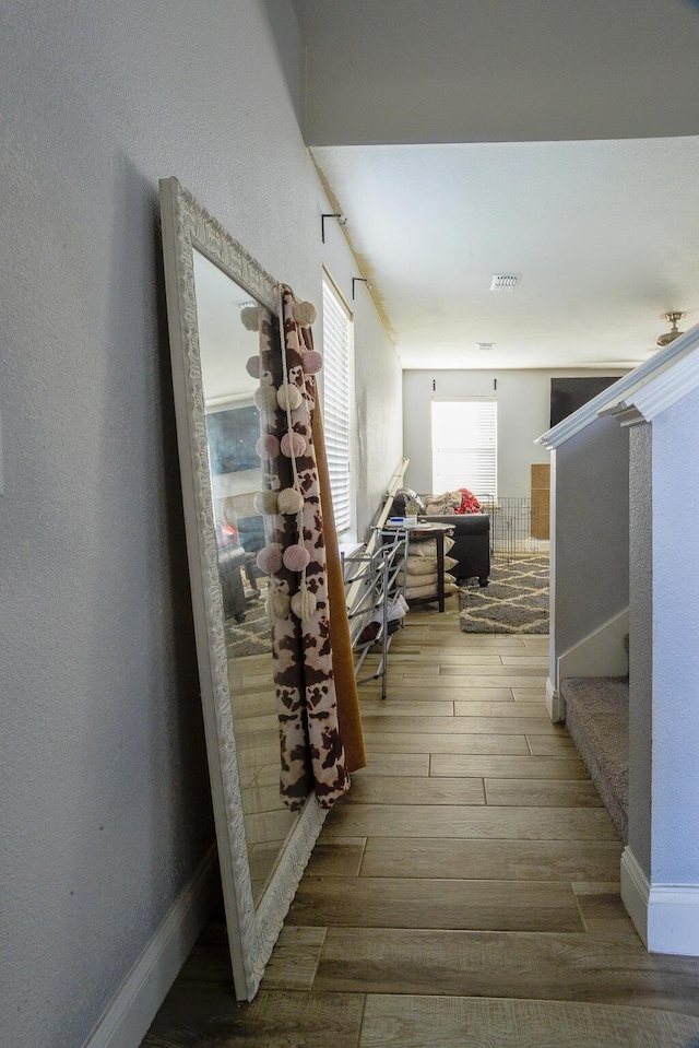 8000 Tee Dr, Austin, TX 78747 - hall featuring wood finished floors, stairway, a textured wall, and baseboards