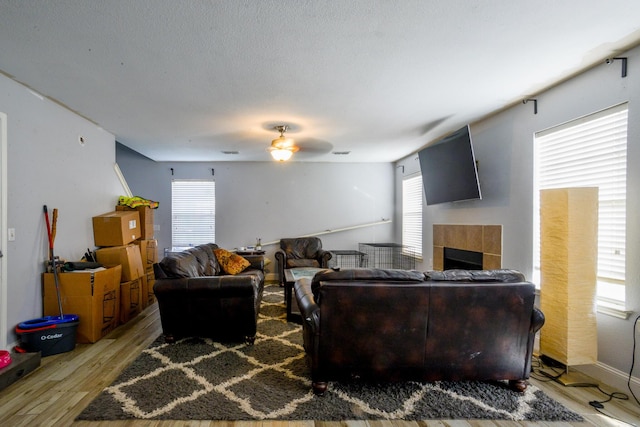 8000 Tee Dr, Austin, TX 78747 - living area with a ceiling fan, light wood finished floors, and a tile fireplace