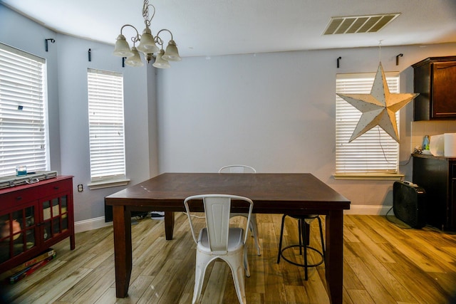 8000 Tee Dr, Austin, TX 78747 - dining area with a chandelier, baseboards, and light wood-type flooring