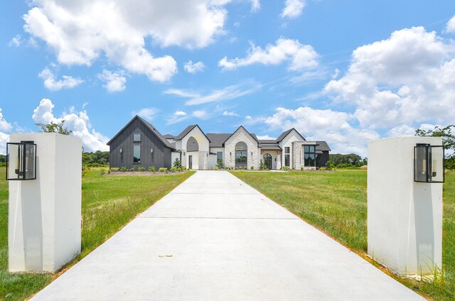 20218 Tealpointe Ridge Ln, Tomball, TX 77377 - view of front of property featuring a front lawn, driveway, stone siding, and a residential view