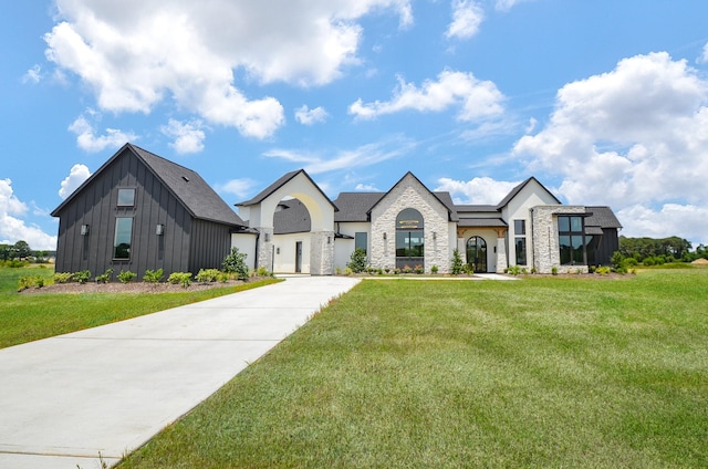 20218 Tealpointe Ridge Ln, Tomball, TX 77377 - view of front of property with a front lawn, stone siding, and board and batten siding