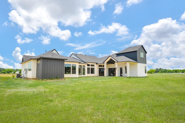 20218 Tealpointe Ridge Ln, Tomball, TX 77377 - back of property with board and batten siding and a lawn