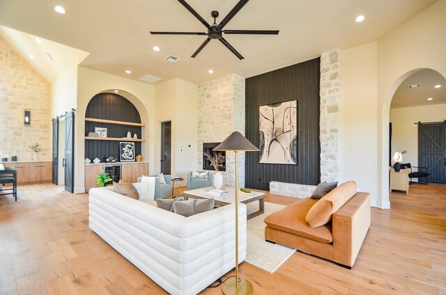20218 Tealpointe Ridge Ln, Tomball, TX 77377 - living room featuring arched walkways, ceiling fan, high vaulted ceiling, recessed lighting, and light wood-style flooring