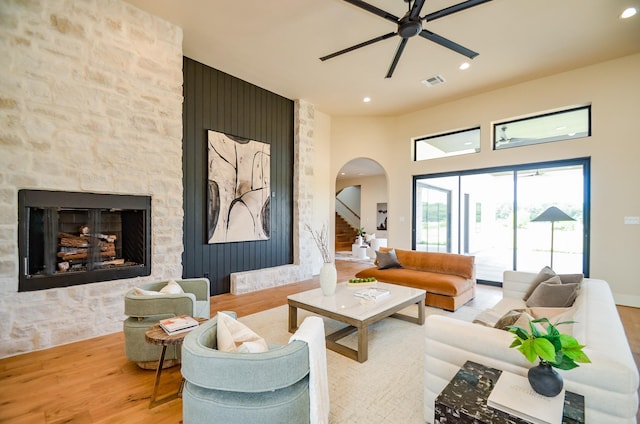 20218 Tealpointe Ridge Ln, Tomball, TX 77377 - living room with arched walkways, ceiling fan, wood finished floors, recessed lighting, and a fireplace