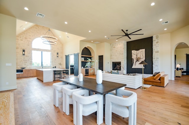 20218 Tealpointe Ridge Ln, Tomball, TX 77377 - dining space featuring arched walkways, ceiling fan, recessed lighting, light wood finished floors, and a chandelier