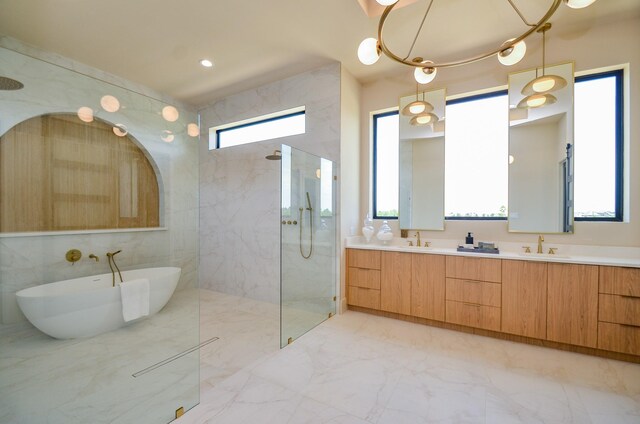 20218 Tealpointe Ridge Ln, Tomball, TX 77377 - full bath with marble tiled flooring, a marble finish shower, double vanity, a soaking tub, and tile walls