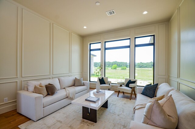 20218 Tealpointe Ridge Ln, Tomball, TX 77377 - living area with a decorative wall, light wood-style flooring, and recessed lighting