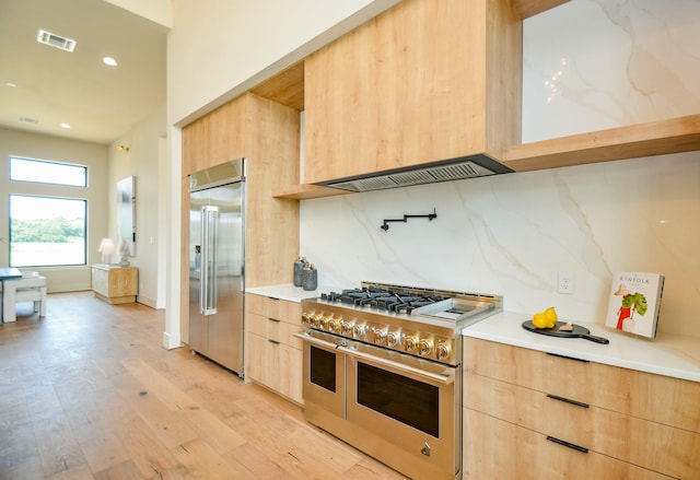 20218 Tealpointe Ridge Ln, Tomball, TX 77377 - kitchen with high quality appliances, light brown cabinetry, modern cabinets, light countertops, and light wood-style flooring