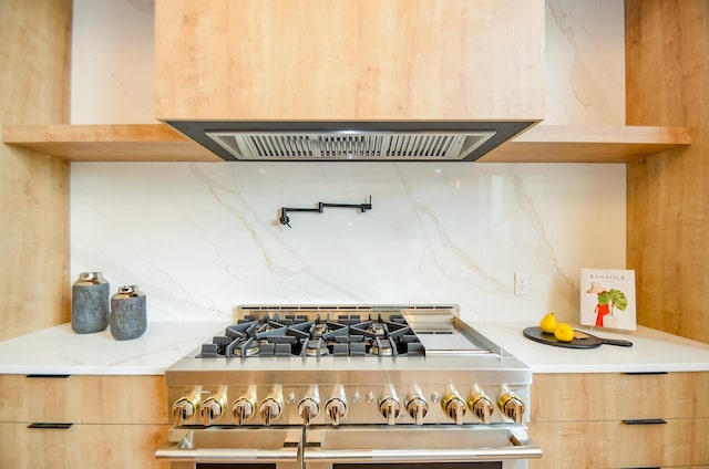 20218 Tealpointe Ridge Ln, Tomball, TX 77377 - kitchen view of stainless steel range, extractor fan, modern cabinets, backsplash, and light brown cabinetry
