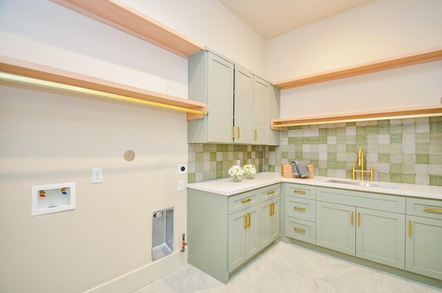 20218 Tealpointe Ridge Ln, Tomball, TX 77377 - laundry room with washer hookup, electric dryer hookup, light marble finish floors, cabinet space, and gas dryer hookup