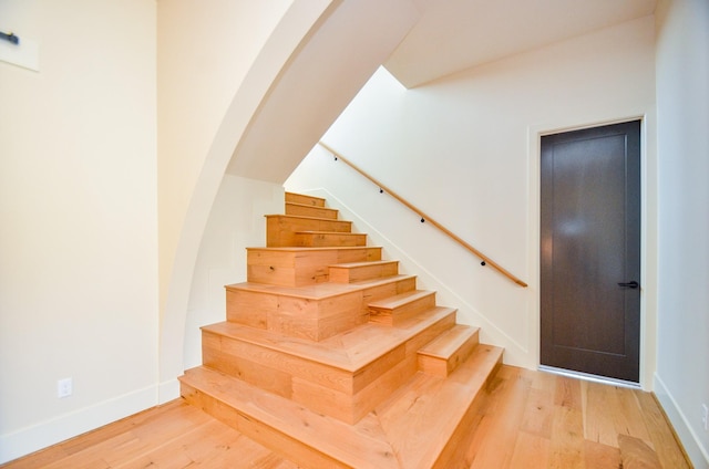 20218 Tealpointe Ridge Ln, Tomball, TX 77377 - staircase with wood finished floors and arched walkways
