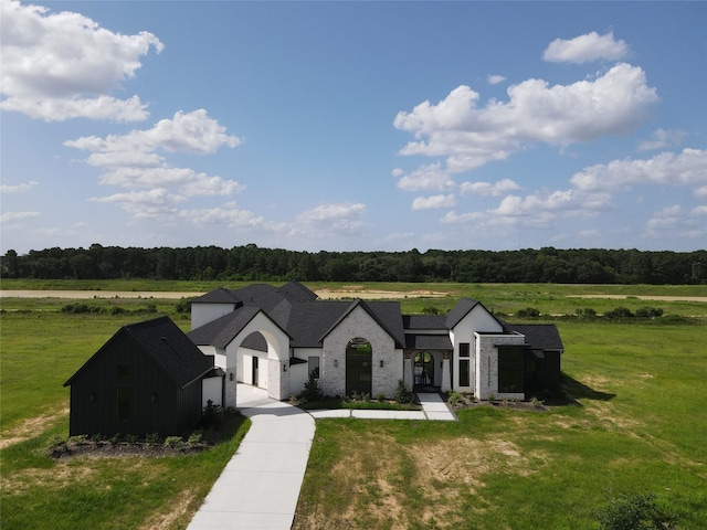 20218 Tealpointe Ridge Ln, Tomball, TX 77377 - view of front of home featuring a front lawn, brick siding, a view of rural / pastoral area, and a wooded view