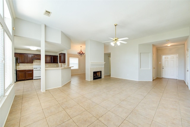 19814 Lindenfield Pl, Katy, TX 77449 - unfurnished living room featuring light tile patterned floors, a ceiling fan, a fireplace, and a sink